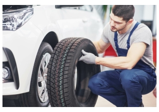 mechanic-holding-tire-tire-repair-garage-replacement-winter-summer-tires-compressed
